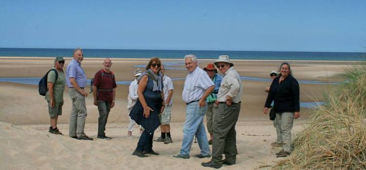 walking group on the beach